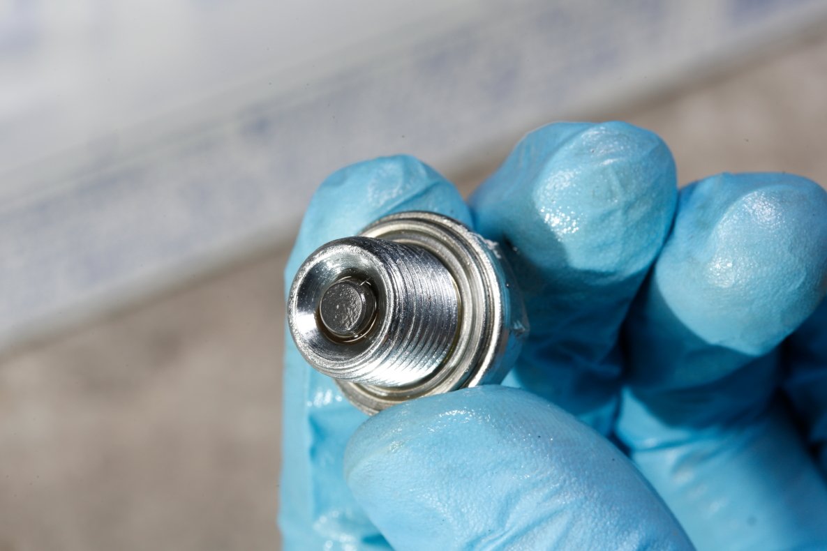 A magnet is set in the drain bolt to catch metal sludge. Prior to restoration, clean with a parts cleaner and replace the filter gasket with a new one.